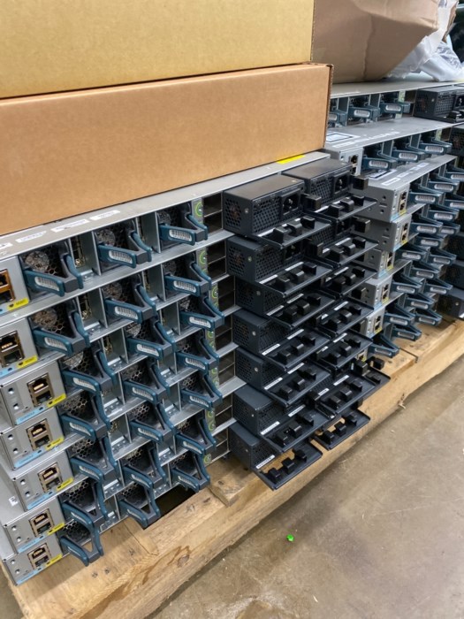 Pallet filled with Cisco switches and accessories for sale